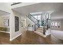 Grand entryway with hardwood floors and a sweeping staircase at 4291 W Lake N Cir, Littleton, CO 80123