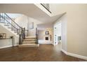 Elegant entryway showcasing hardwood floors and staircase at 4291 W Lake N Cir, Littleton, CO 80123