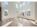 Bright living room with large windows and plank flooring for a sleek modern aesthetic at 4600 Thistle Dr, Brighton, CO 80601