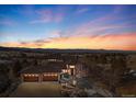Beautiful home featuring a front yard, large driveway, and an attached three-car garage at sunset at 10370 Grande Vista Ct, Lone Tree, CO 80124