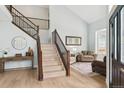 Spacious entryway with hardwood floors, staircase, and views of the living area at 10029 Winterthur Ct, Highlands Ranch, CO 80129