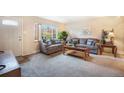 Cozy living room with neutral decor, large windows, plush seating, and ample natural light at 12323 W Connecticut Dr, Lakewood, CO 80228