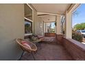 Inviting front porch featuring slate floors and sitting area with view of quiet neighborhood street at 3420 Julian St, Denver, CO 80211