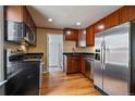 Well-equipped kitchen with stainless steel appliances, wooden cabinets, and hardwood flooring at 3420 Julian St, Denver, CO 80211