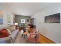 Cozy living room featuring wood floors, neutral paint colors, and space for dining at 3420 Julian St, Denver, CO 80211