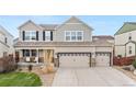 Inviting two-story home with a covered porch and a three car garage featuring stone accents at 10158 Granby St, Commerce City, CO 80022