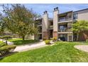Well-manicured lawns surround this multi-unit residential building with private balconies at 519 Wright St # 108, Lakewood, CO 80228