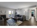 Cozy living room with fireplace and access to outdoor patio at 519 Wright St # 108, Lakewood, CO 80228