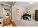 Bright living room with hardwood floors and a grand piano at 40 Ferris Ln, Erie, CO 80516