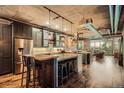Modern kitchen with stainless steel appliances, bar seating, and exposed brick accents at 1401 Wewatta St # 308, Denver, CO 80202