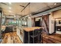 Contemporary kitchen featuring an island with bar seating and rustic barn-style doors at 1401 Wewatta St # 308, Denver, CO 80202