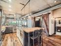 Kitchen featuring a breakfast bar, an island with a white countertop, and sliding barn doors at 1401 Wewatta St # 308, Denver, CO 80202