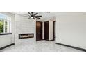 Bright living room features a fireplace and modern lighting at 3226 W Dakota Ave, Denver, CO 80219