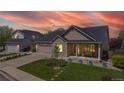Charming single-Gathering home boasts a well-manicured lawn, a two-car garage and a welcoming front porch at 14833 Vine St, Thornton, CO 80602