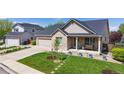 Beautiful single-Gathering home boasting a well-maintained lawn, brick facade, and inviting front porch at 14833 Vine St, Thornton, CO 80602