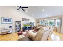 The spacious living room features a vaulted ceiling, hardwood floors, and a large bay window overlooking the front yard at 14833 Vine St, Thornton, CO 80602