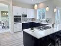 Modern kitchen with stainless appliances, quartz counters and two-tone cabinets at 22019 E Arbor Dr, Aurora, CO 80016
