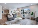 Bright and airy living room featuring modern decor, a large window, and an open floor plan at 9972 Wheeling St, Commerce City, CO 80022