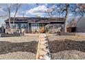 Charming ranch home with gray siding, stone accents, and mature trees at 3088 S Grape Way, Denver, CO 80222