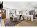 Bright living room with hardwood floors, fireplace, and open concept design at 3088 S Grape Way, Denver, CO 80222