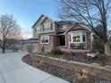 Landscaped two-story home with brick accents, bay window and three-car garage at 2522 W Dry Creek Ct, Littleton, CO 80120