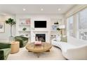 Bright living room with custom shelving, fireplace, and stylish furniture and decor at 3221 Perry St, Denver, CO 80212