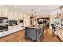 Spacious kitchen with a large center island, modern appliances, and hardwood floors at 14118 Whitney Cir, Broomfield, CO 80023