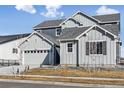 Gorgeous two-story home with a spacious two car garage, a driveway and xeriscape landscaping at 16075 E 109Th Pl, Commerce City, CO 80022