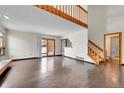 Open-concept living room with abundant natural light, sliding glass doors, and a staircase at 13028 Garfield Dr, Thornton, CO 80241