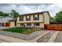 Exterior view of a two story home featuring a manicured front lawn and gravel landscaping at 9766 Fillmore St, Thornton, CO 80229