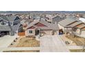 Aerial view of home with a large driveway and professional landscaping nestled in a quiet neighborhood at 6817 Sequoia St, Frederick, CO 80530