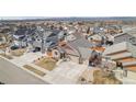 An aerial view of the home and neighborhood, with a lush green lawn and mature trees at 6817 Sequoia St, Frederick, CO 80530