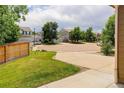 A quiet neighborhood street features well-kept homes and mature trees, showcasing community charm at 9215 W Swarthmore Dr, Littleton, CO 80123