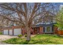 Charming two-story brick home featuring mature trees in the front yard at 16222 E Prentice Ln, Centennial, CO 80015