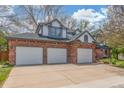 Charming two-story brick home featuring a three-car garage and a well-maintained front yard at 16222 E Prentice Ln, Centennial, CO 80015