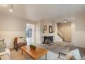Bright living room featuring hardwood floors, a fireplace, and lots of natural light at 404 Raspberry Ln, Monument, CO 80132