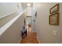Bright hallway featuring hardwood floors and access to the living area, creating an inviting transition space at 12856 King St, Broomfield, CO 80020