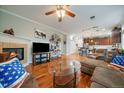Open living space with hardwood floors, a fireplace, and seamless transition to the modern kitchen area at 12856 King St, Broomfield, CO 80020