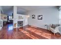 Living room with hardwood floors, a fireplace, and lots of natural light at 4443 E Bennington Ave, Castle Rock, CO 80104