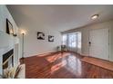 Living room featuring hardwood floors, bay window, and fireplace at 4443 E Bennington Ave, Castle Rock, CO 80104