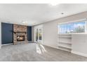 Bright living room boasts a brick fireplace, sliding doors, and ample natural light through large windows at 1793 S Nucla St, Aurora, CO 80017