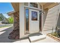 Inviting front entrance with glass accents and a well-maintained exterior at 6803 W Yale Ave, Lakewood, CO 80227