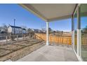 Covered back patio area with views of a fenced yard at 2670 E 102Nd Pl, Thornton, CO 80229