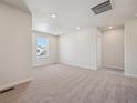 Bright, carpeted bedroom featuring recessed lighting, a large window, and neutral walls at 19088 E 94Th Pl, Commerce City, CO 80022