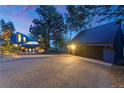 Stunning exterior view of a contemporary home with a large driveway and two-car garage at 5396 Bear Mountain, Evergreen, CO 80439