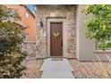 Charming front door entrance with stone surround and decorative wreath at 2429 S Orchard St, Lakewood, CO 80228