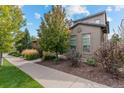 Landscaped front yard features a beautiful walkway to the home's entrance at 2429 S Orchard St, Lakewood, CO 80228
