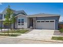 Well-maintained single-Gathering home featuring stone accents, a two-car garage and a manicured lawn at 9091 Telluride Ct, Commerce City, CO 80022