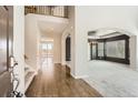 Open foyer featuring hardwood floors, staircase with wrought iron railing and access to the living and dining spaces at 1905 Graphite Ct, Castle Rock, CO 80108