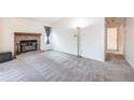 Living room with fireplace and hardwood floors at 5341 W 76Th Ave # 221, Arvada, CO 80003